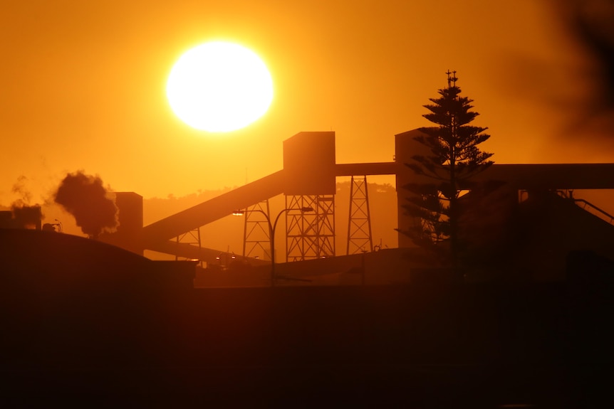 A sunrise scene over an industrial precint