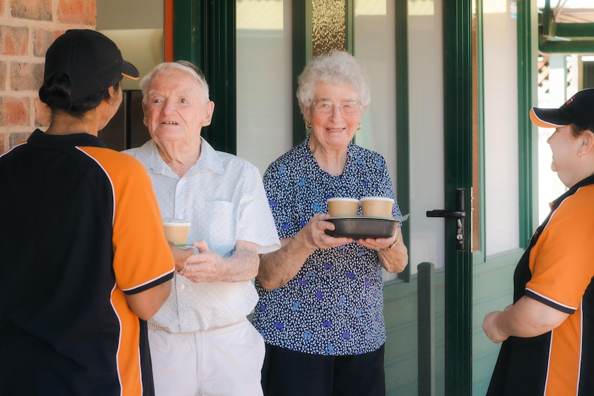 Workers delivering meals to elderly people. 