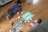 Brad Stokes and daughter Olive stay dry playing board games