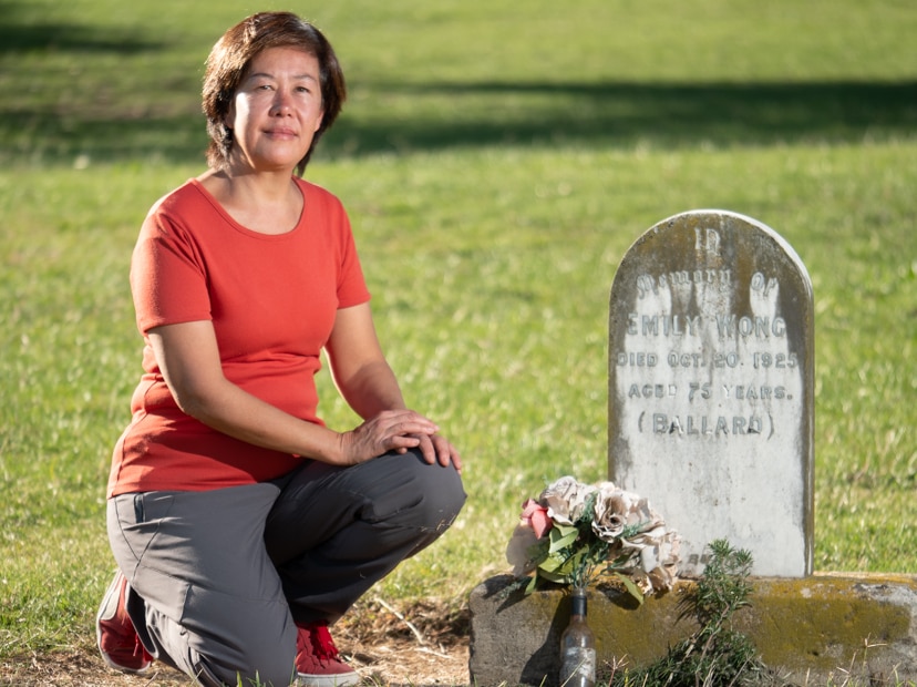 Juanita Kwok kneeling beside a gravesite