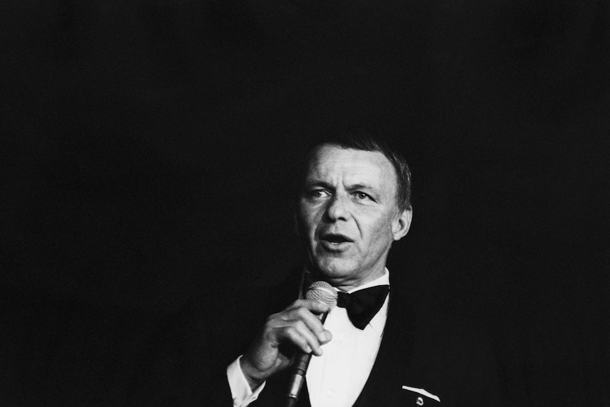 Black-and-white image of Frank Sinatra, in performance; circa 1970; New York.