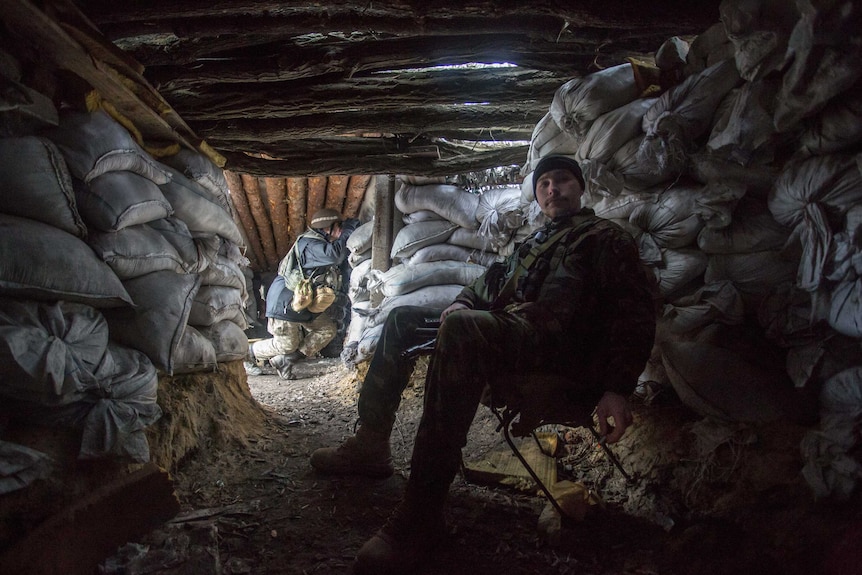 Ukrainian scout looks through binoculars.