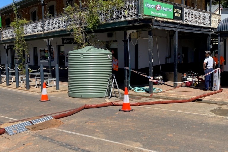 Hoses running out of a pub with part of the area sectioned off 
