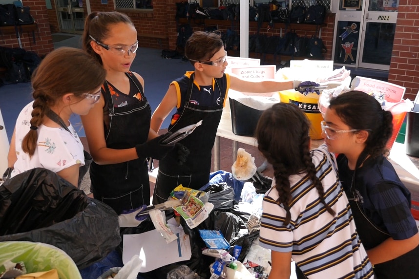 Students help sort the rubbish during an audit.
