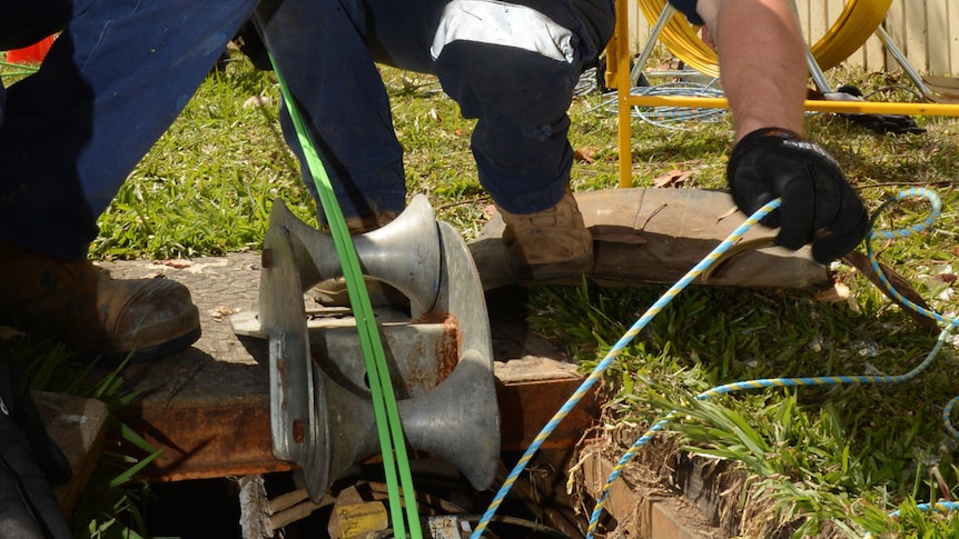 Workers installing fibre-optic cable as part of NBN rollout.