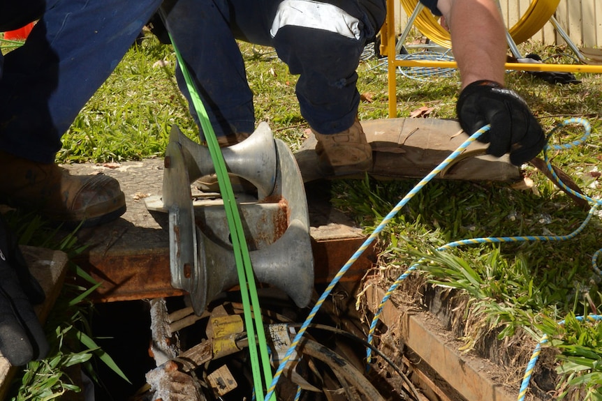 Workers install fibre-optic cable