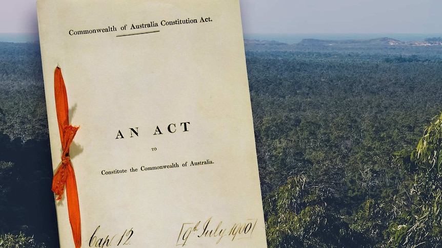 A ribbon bound version of Australia's constitution with a photo of the Australian outback in the background.