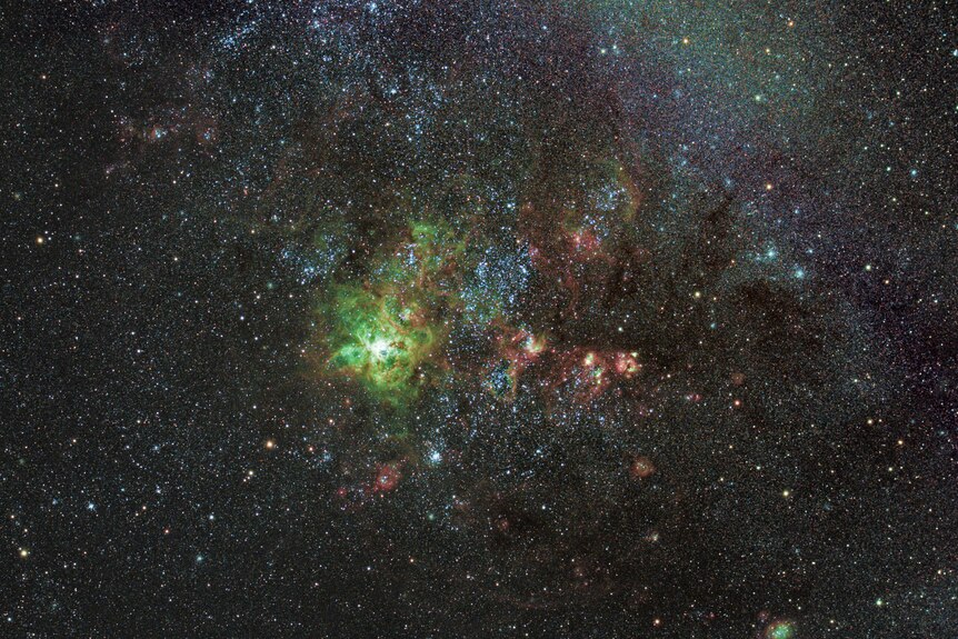 A cluster of stars that are green, blue and orange
