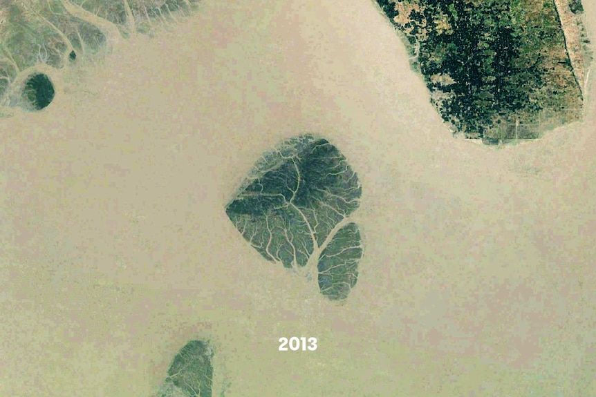 A satellite images of a small island, part of it is underwater