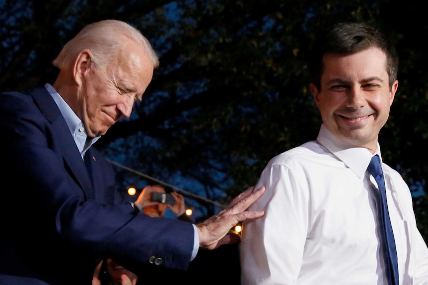 Joe Biden and Pete Buttigieg smiling together at a campaign rally