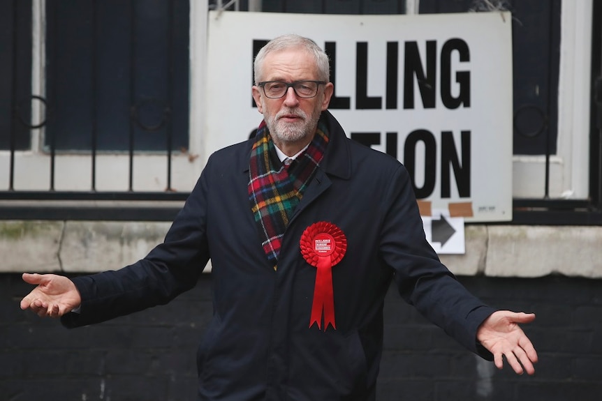 British opposition Labour Party leader Jeremy Corbyn, standing in front of a polling station sign.
