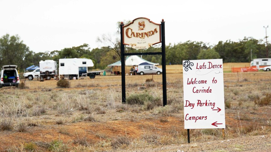 A handwritten sign welcomes visitors to Let's Dance Carinda, and a sign in the background welcomes visitors to the town itself.