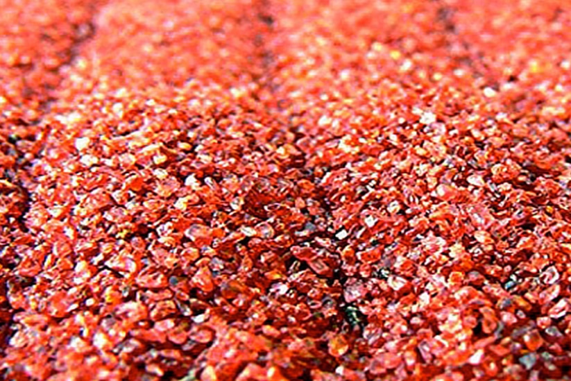 Close up of small red garnet fragments