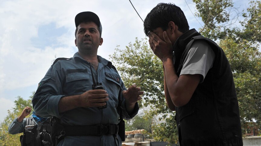 An Afghan man cries at the site of the suicide bomb attack in the Kabul's diplomatic quarters.