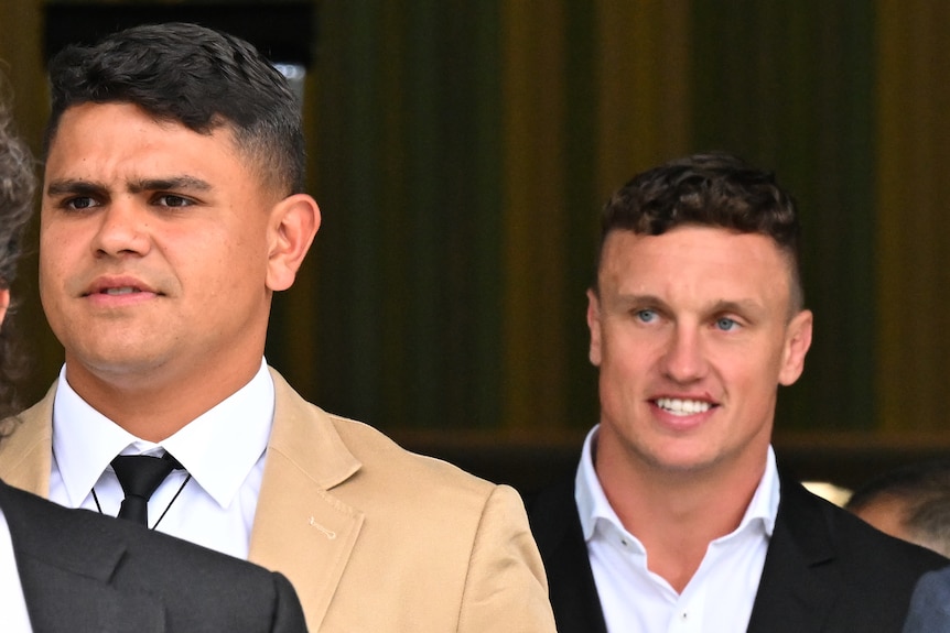Latrell Mitchell and Jack Wighton leave court.