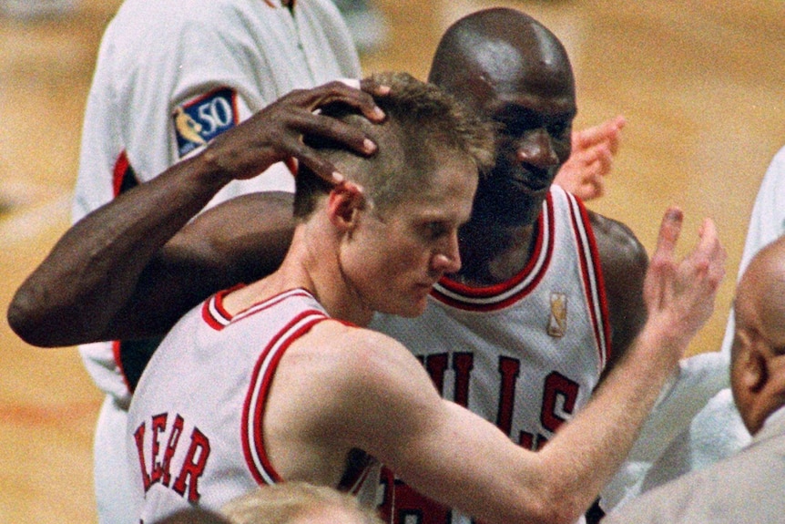 Chicago Bulls teammates Steve Kerr and Michael Jordan hug after a game.