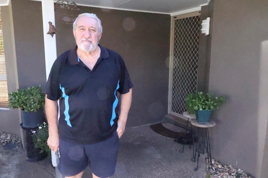 A man standing outside his house