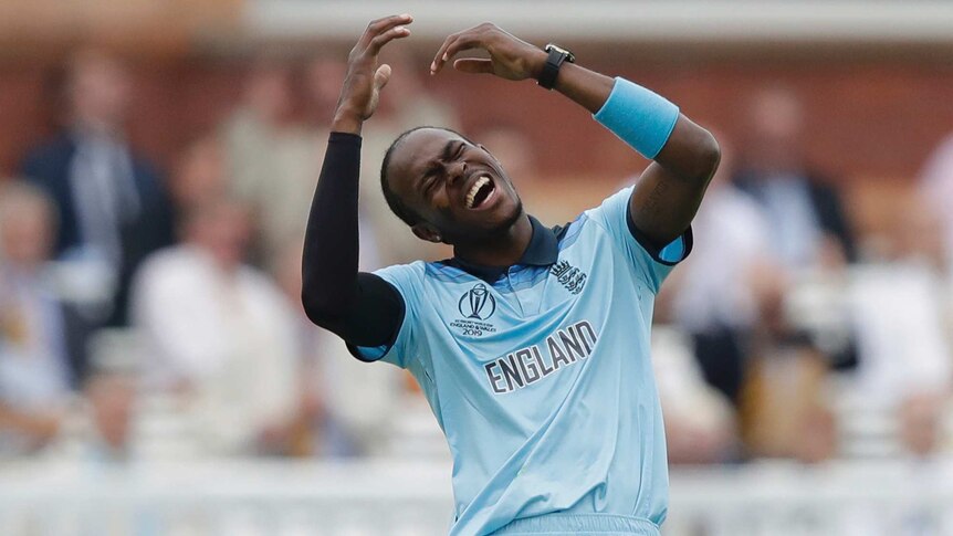 Jofra Archer closes his eyes, opens his mouth and raises his arms as he contorts himself in an anguished expression