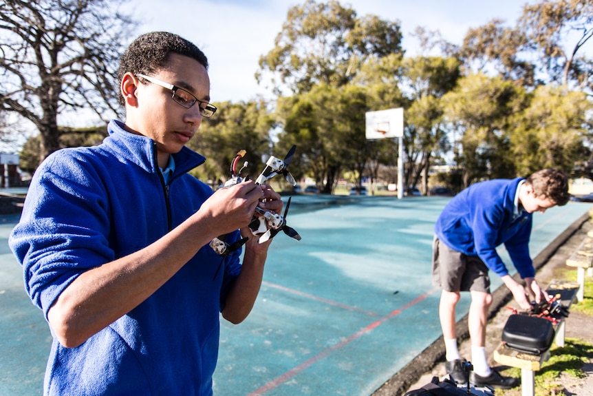 Nathaniel and Cale at school getting ready to fly their drones.