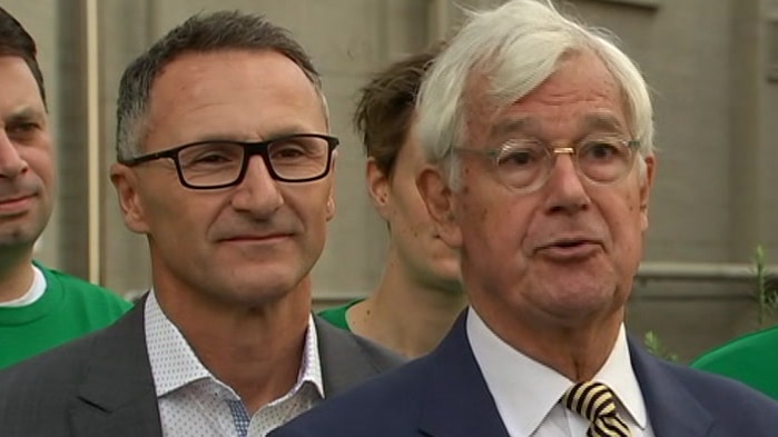Richard Di Natale and Julian Burnside stand side by side at a press conference.