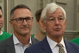 Richard Di Natale and Julian Burnside stand side by side at a press conference.
