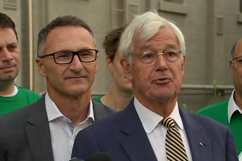 Richard Di Natale and Julian Burnside stand side by side at a press conference.