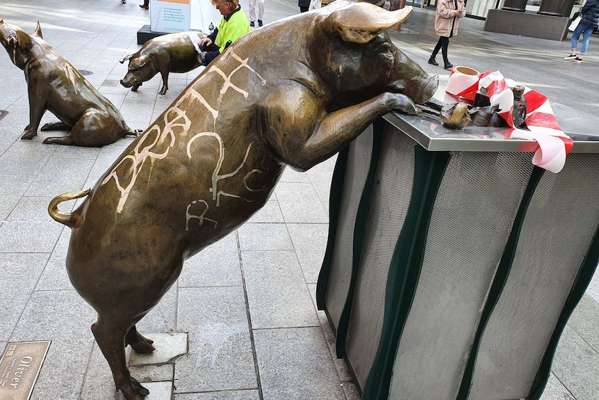 A vandalised sculpture of a pig.