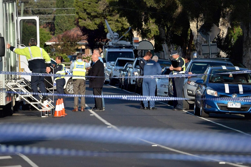 Police fill the street outside the house on Darebin Drive, Thomastown.