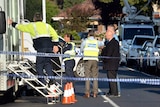 Police fill the street outside the house on Darebin Drive, Thomastown.