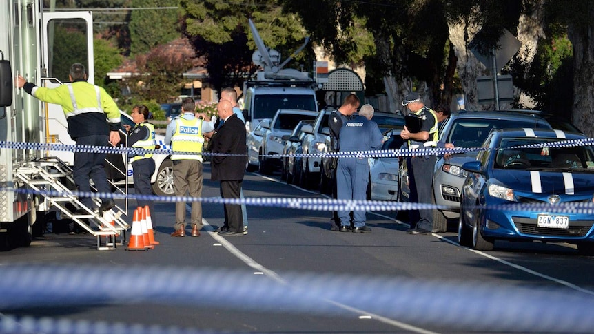 Police fill the street outside the house on Darebin Drive, Thomastown.