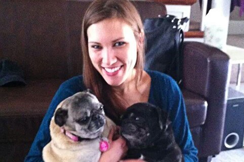 A woman with two pugs