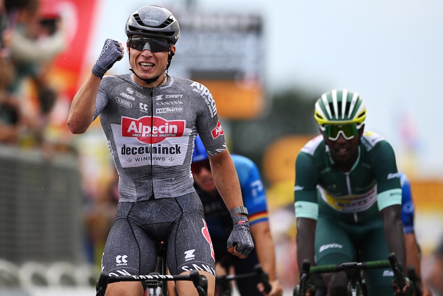 Jasper Philipsen  pumps his fist on his bike as he celebrates winning Tour de France 10th stage.