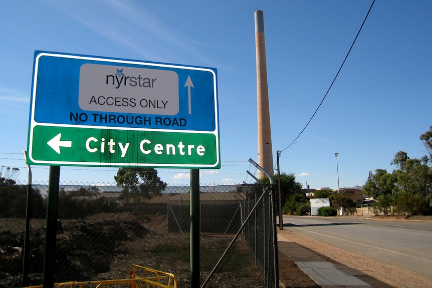 A road and sign saying 'Nystar access only' and an arrow next to the words 'city centre' 