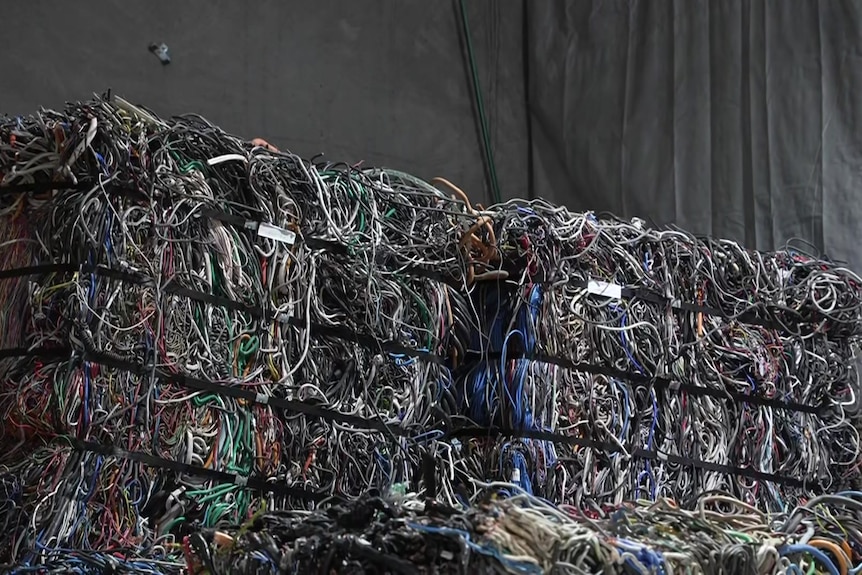 a large stockpile of plastic cords that has been stacked. 