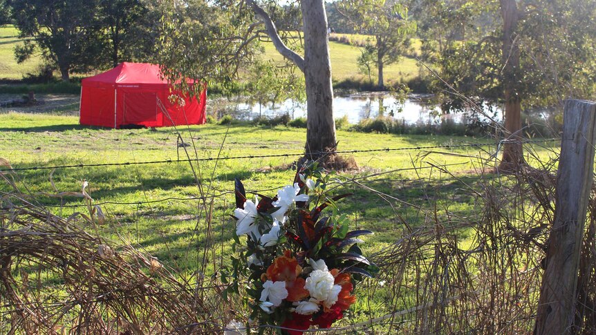 Flowers left on a fence near the dam where a 3yo girl drowned.