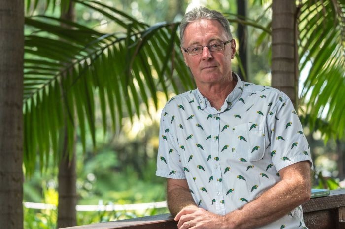 Urban ecologist Darryl Jones, a white man with grey hair and glasses, wearing a short, white button-up shirt.