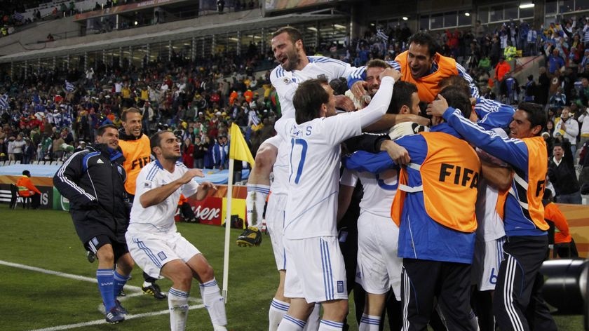 Ecstasy: Vasilis Torosidis's winner secured Greece's first victory in World Cup finals history.