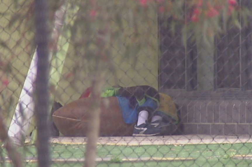 A boy sitting outside in a beanbag at the Merriang Special Development School