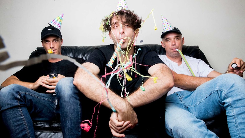 A 2017 press shot of Thundamentals celebrating 10 years with party hats and party poppers