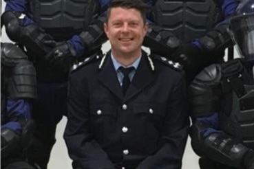 A man wearing a dark blue uniform