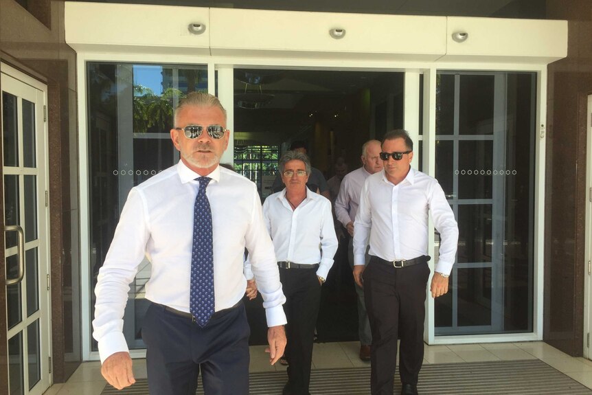 Kristos Diamandopoulos, centre, walks out of Darwin's Supreme Court