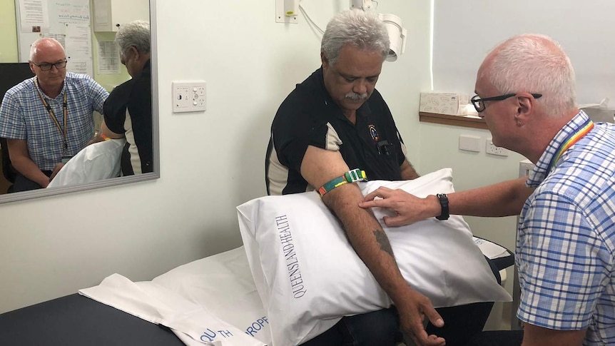 Dr Darren Russel doing a blood test in Cairns