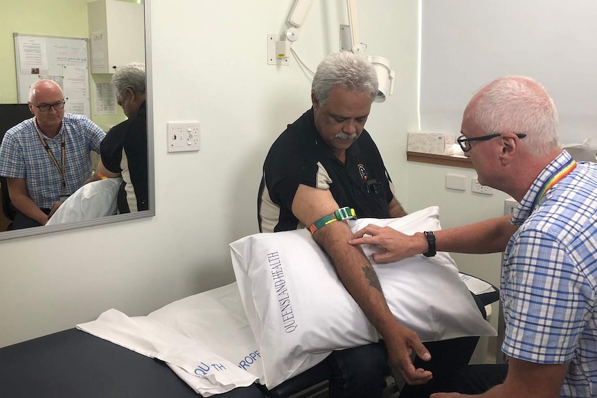 Dr Darren Russel doing a blood test in Cairns