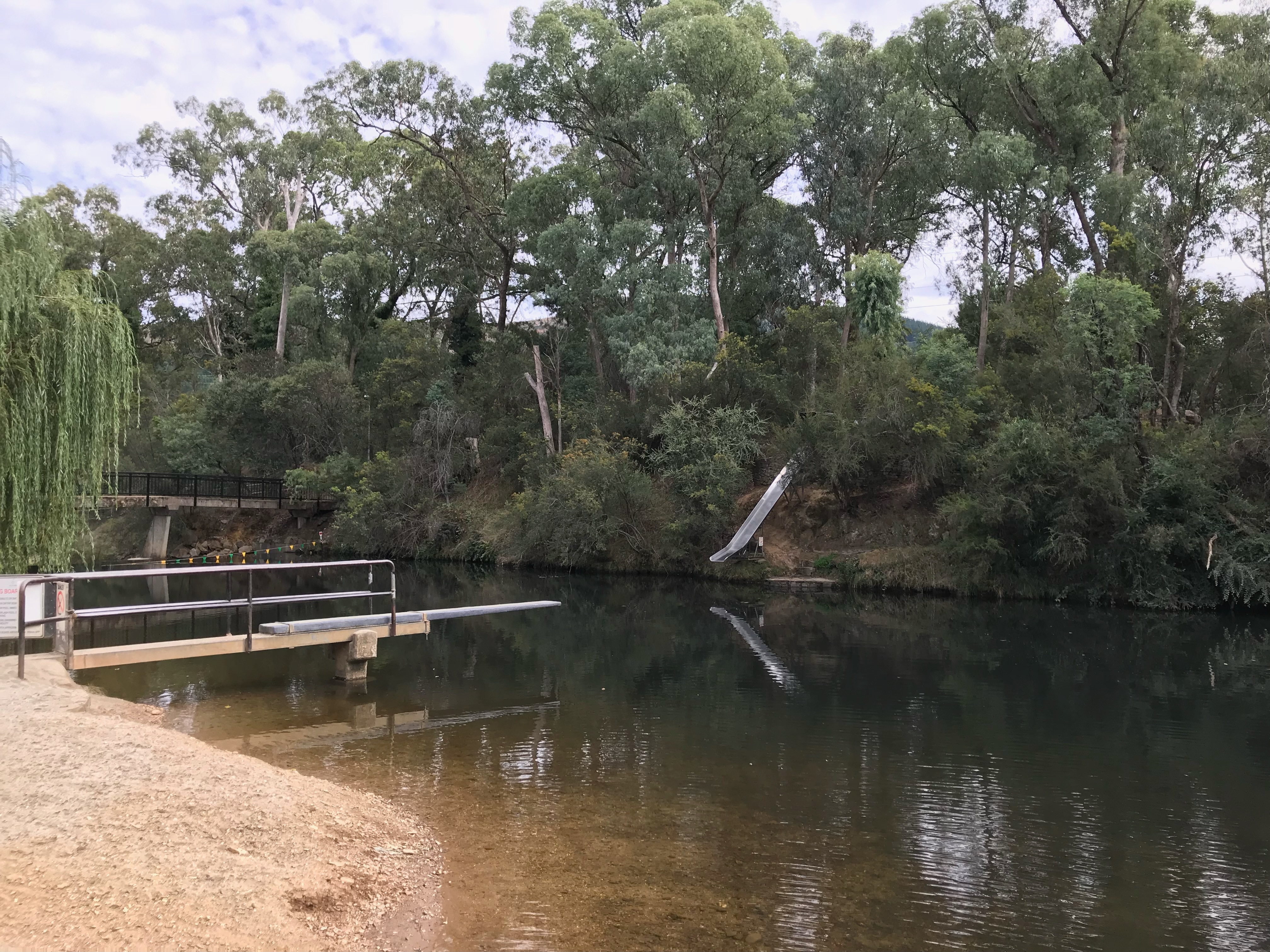 The ovens river with a jumping board extending out into the water.