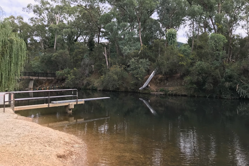 The ovens river with a jumping board extending out into the water.