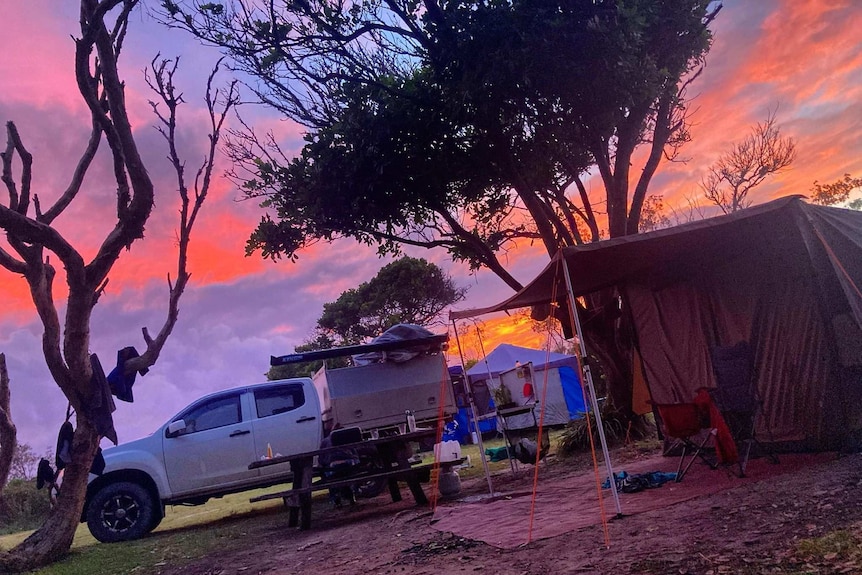 The sun setting over a campsite.