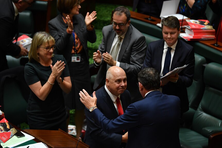 Tim Pallas shakes hands with Daniel Andrews in Victoria's lower house.