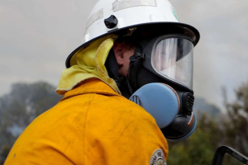 An unidentified firefighter with helmet and breathing apparatus on.