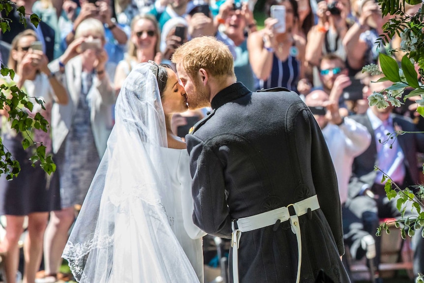 Meghan Markle and Prince Harry kiss on the steps of St George's Chapel