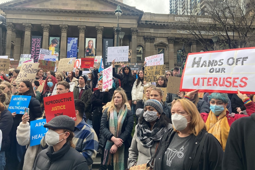 A crowd of people advocating abortion access outside the State Library of Victoria.